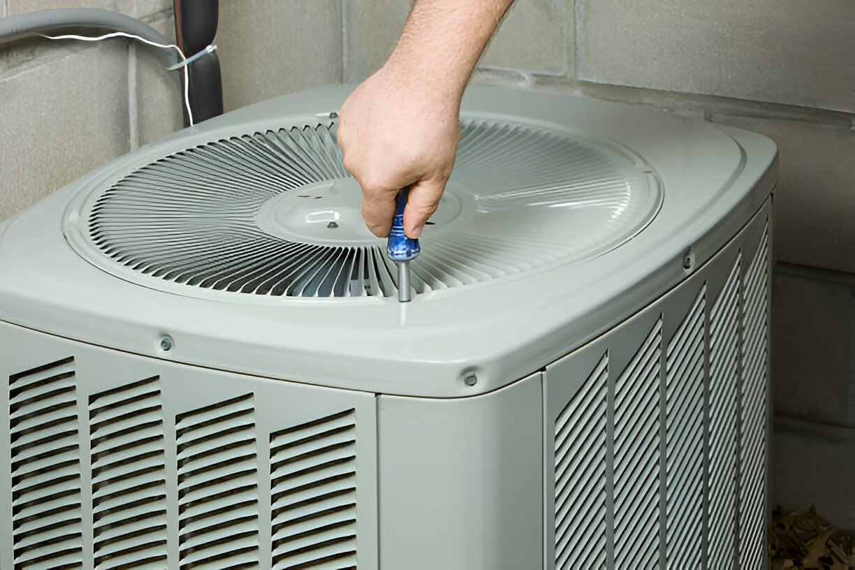 Technician adjusting a new AC unit