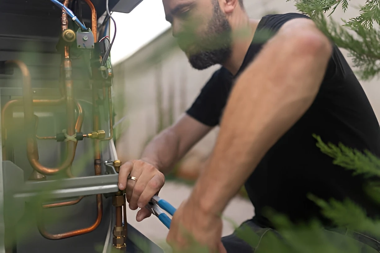 hvac technician repairing heat pump