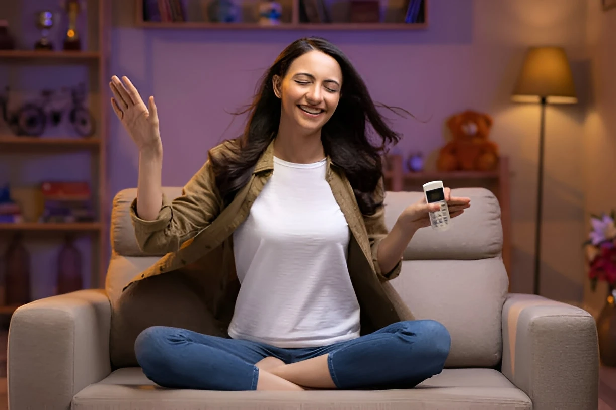 happy lady with mini split controller in hand