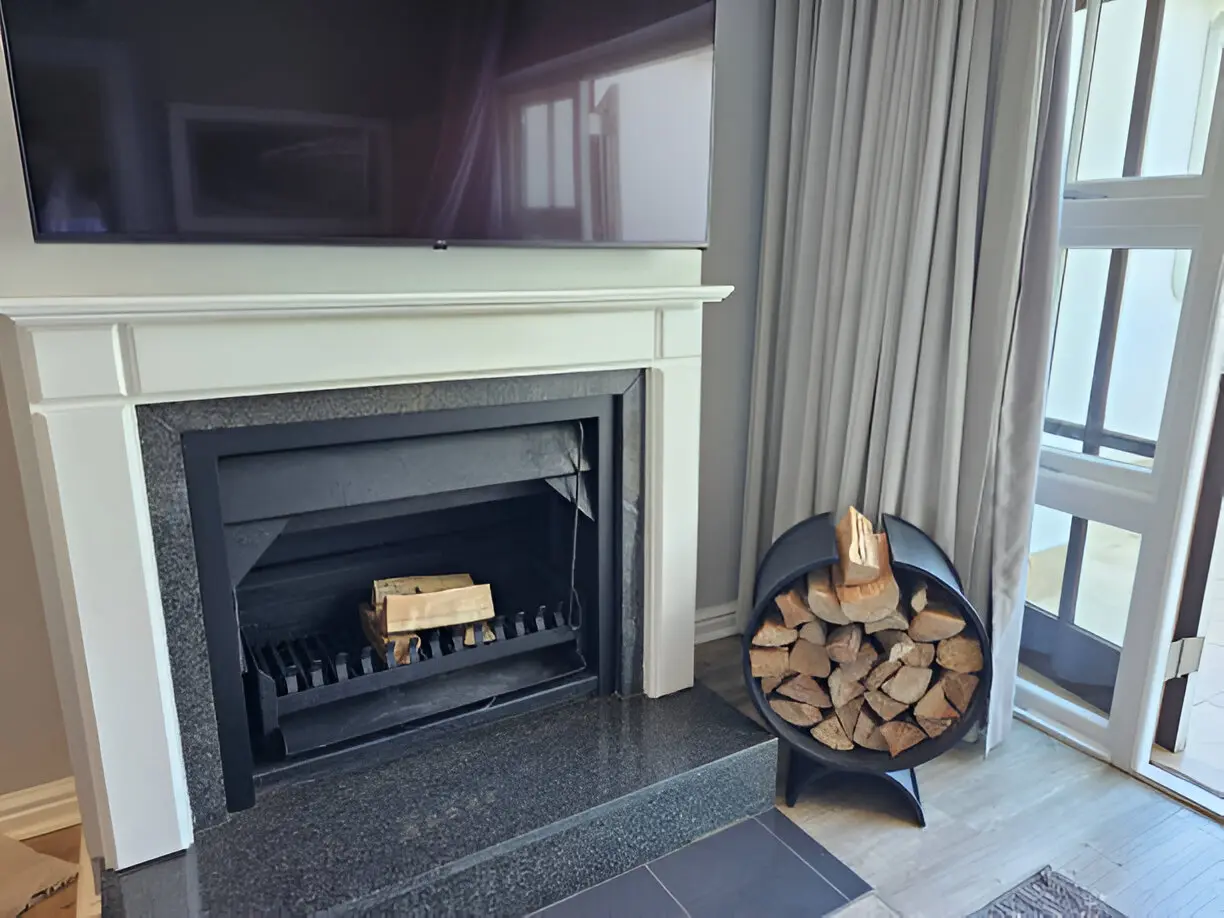 black fireplace with logs on it