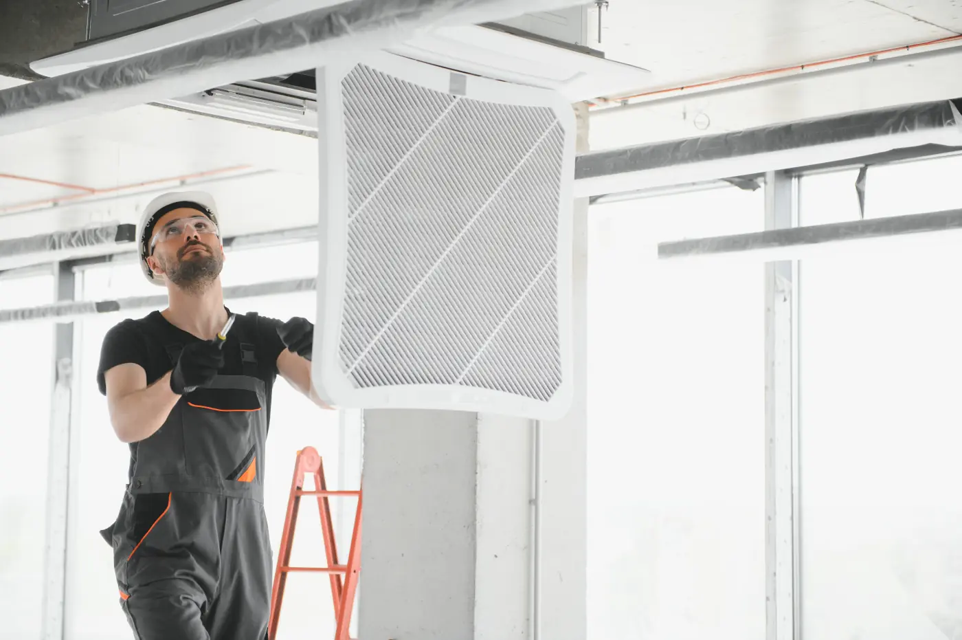 commercial hvac technician verifying vents filter
